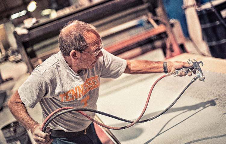 man spraying with hose